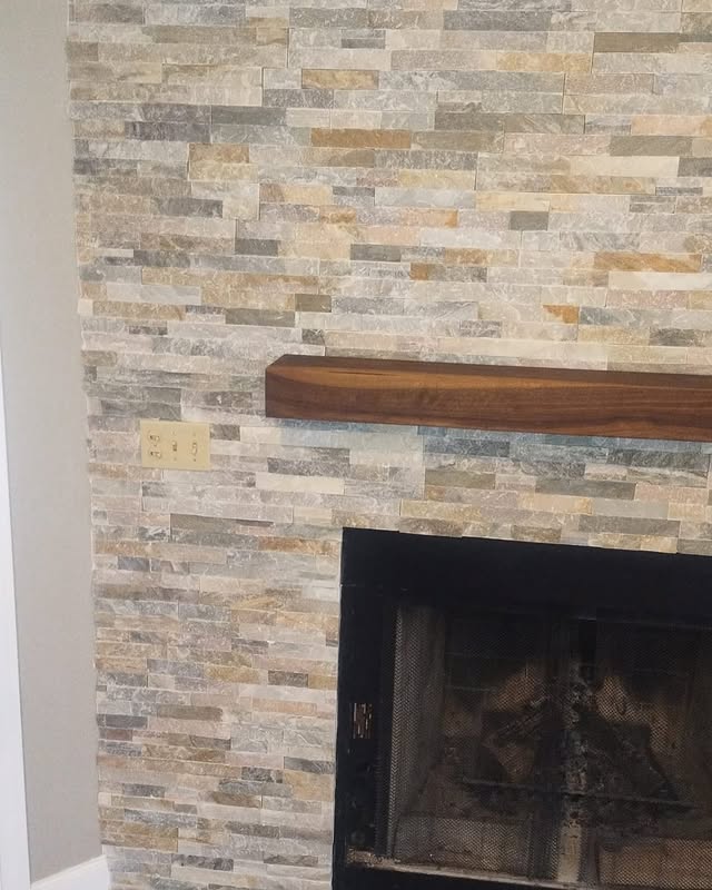 Stacked stone fireplace with live-edge wood mantel