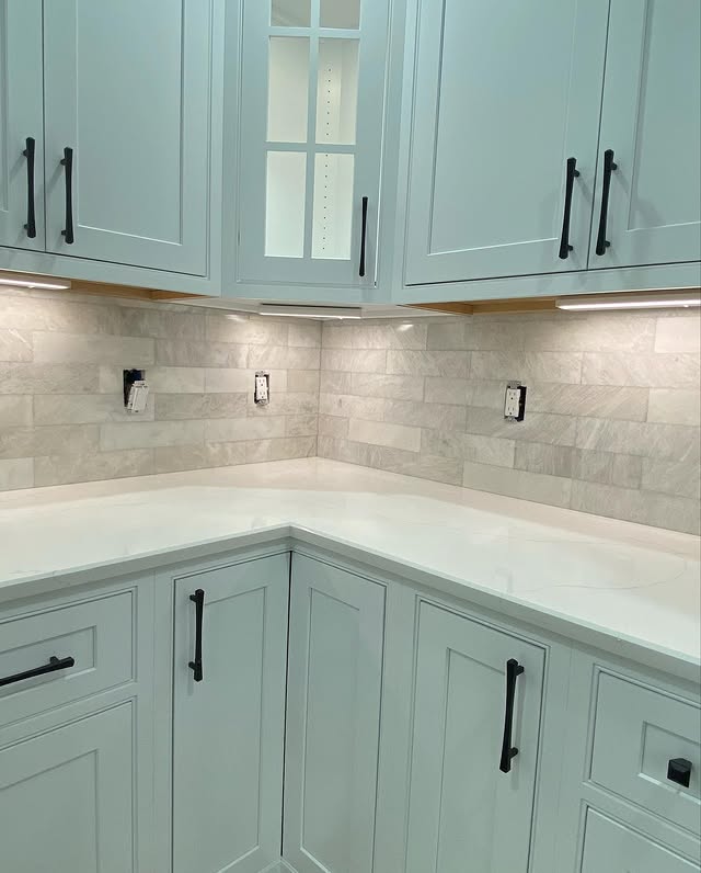 Sage green kitchen with marble subway backsplash